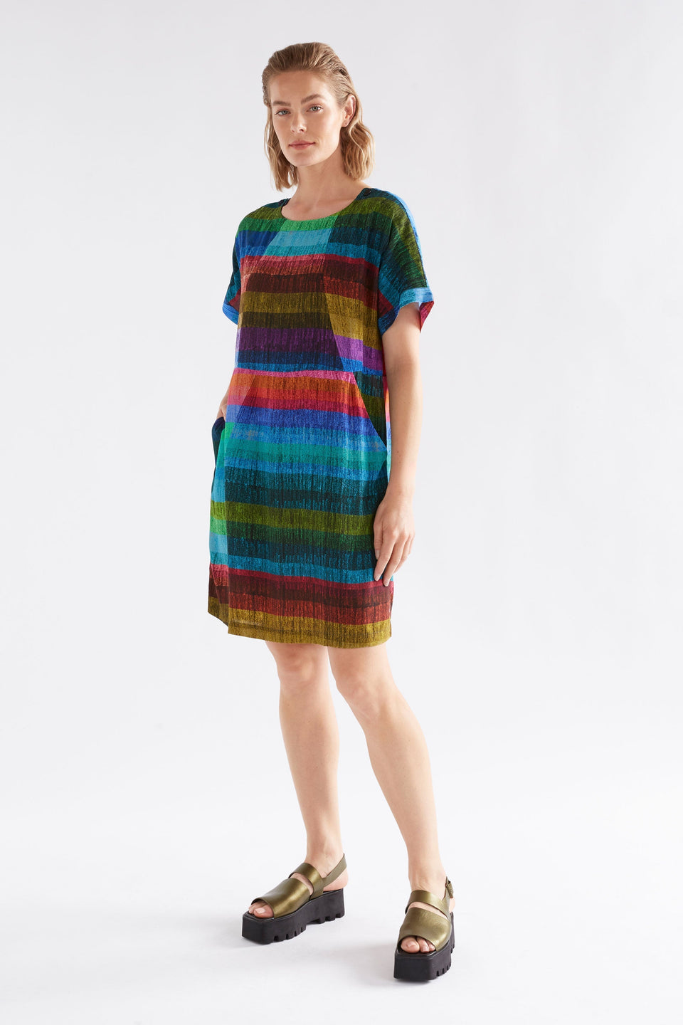 Sono Multi-coloured Stripe Print T-shirt Short Dress with Front Side Pockets Model Angled Front | KOMI PRINT
