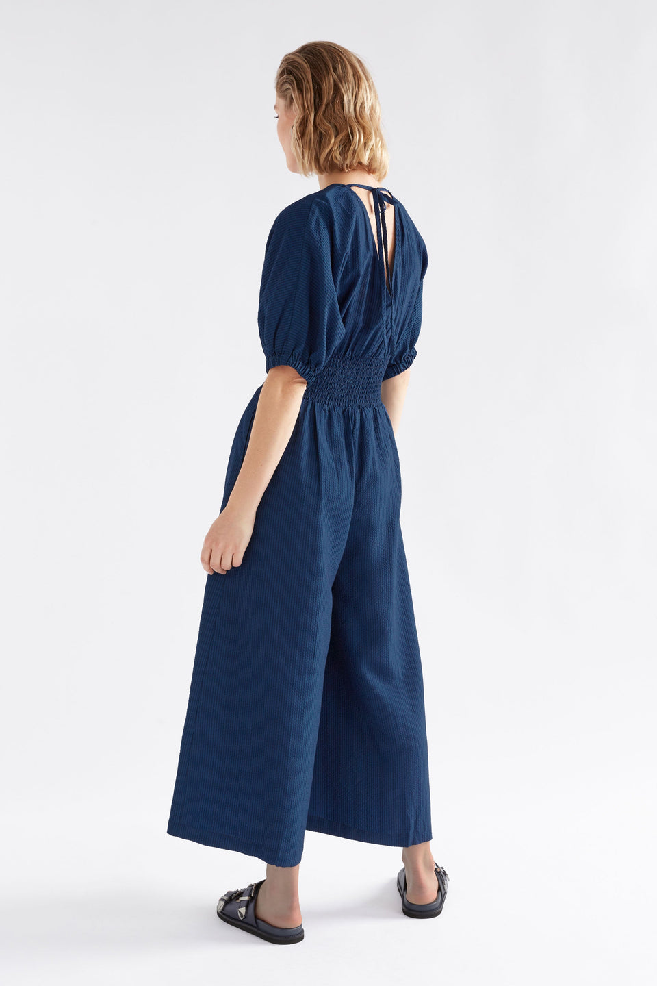Stolt Seersucker Short Puff Sleeve Wide Leg Shirred Waist V-neck Jumpsuit ELK Model Back | MID WASH