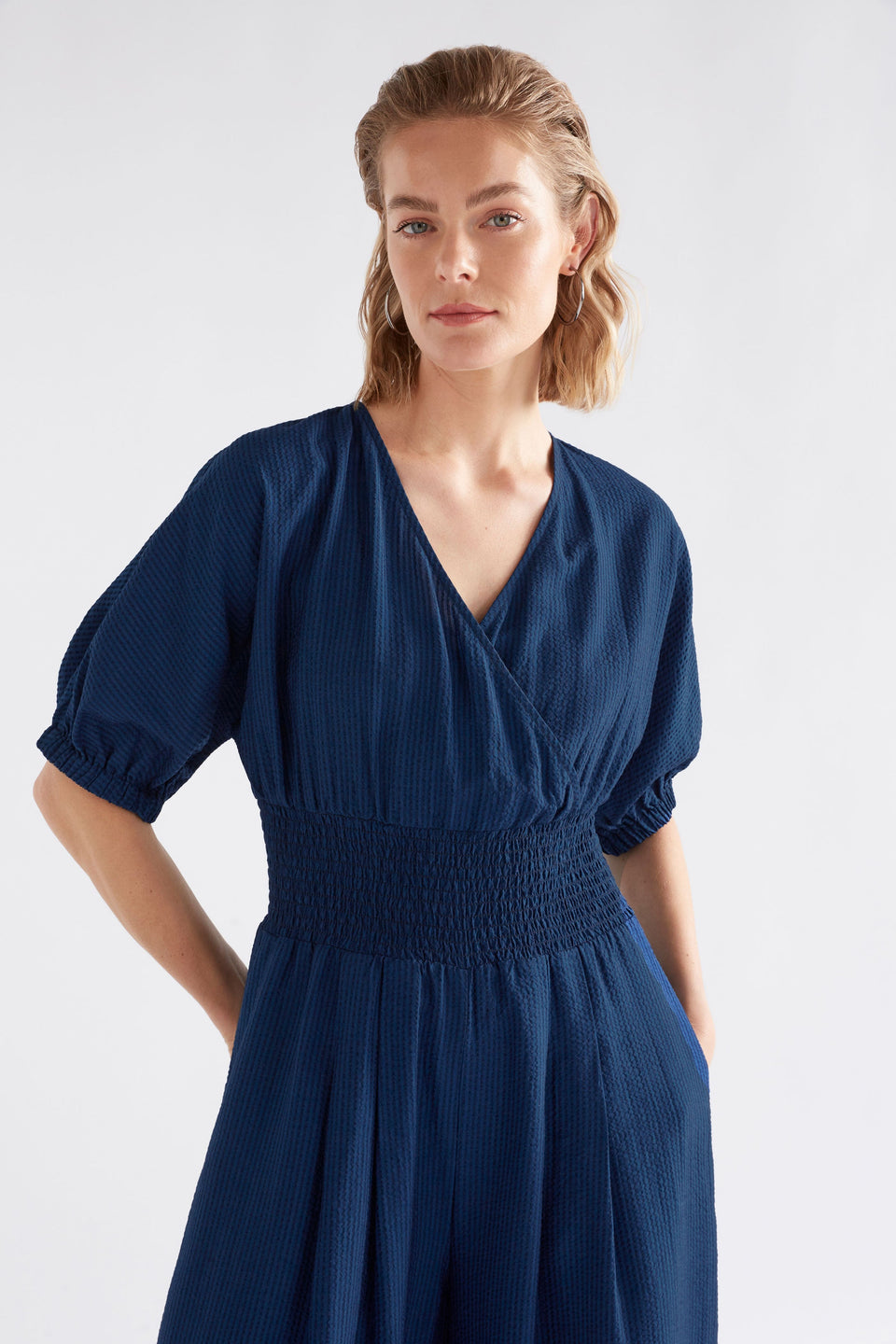 Stolt Seersucker Short Puff Sleeve Wide Leg Shirred Waist V-neck Jumpsuit ELK Model front crop | MID WASH