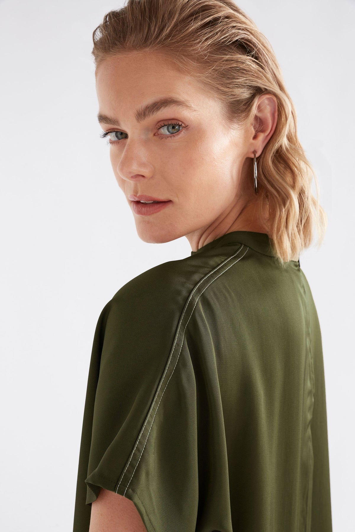 Hullu Relaxed Short Sleeve High Neck Top with Handkerchief Hem Model Front detail | BRIGHT OLIVE