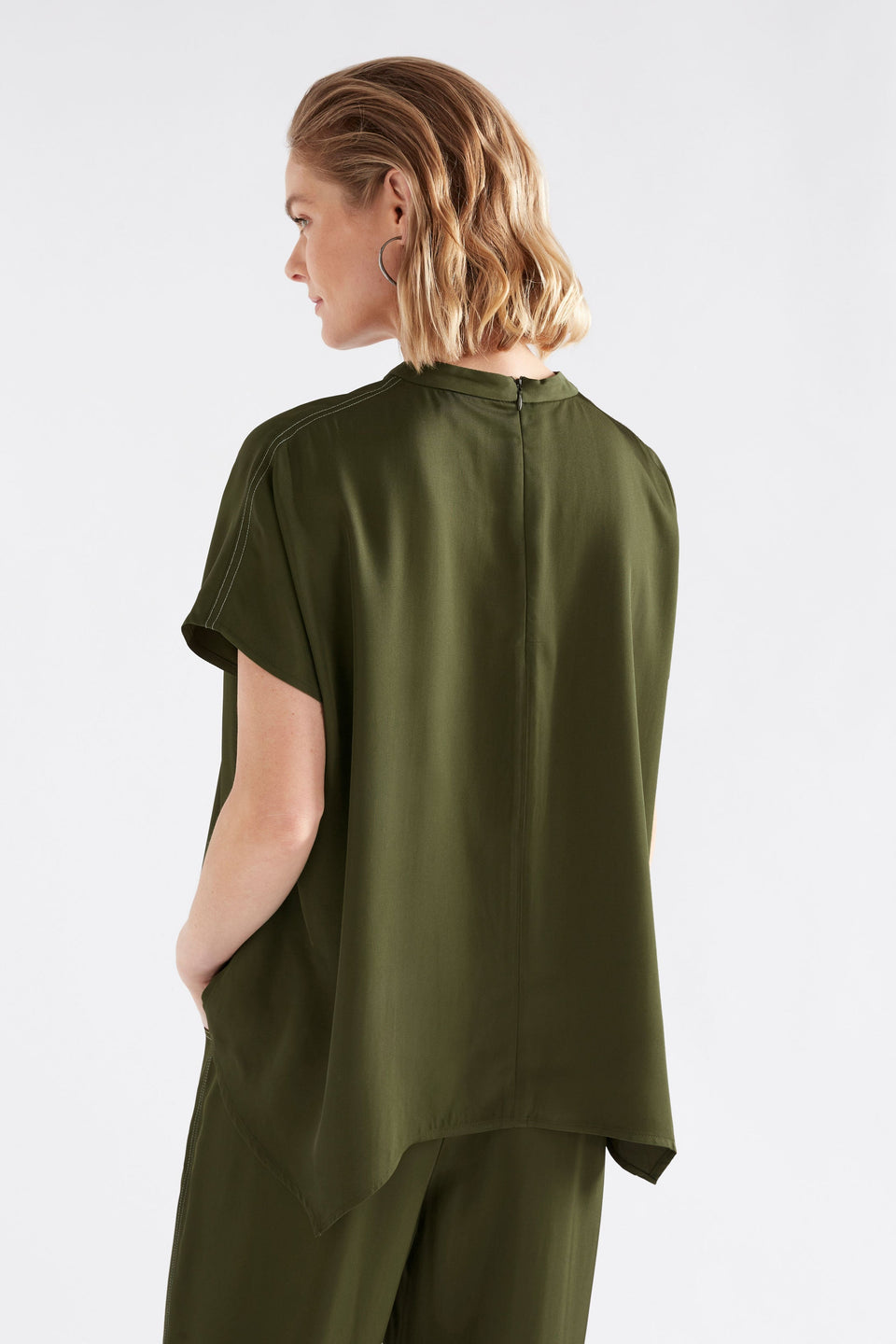 Hullu Relaxed Short Sleeve High Neck Top with Handkerchief Hem Model Back | BRIGHT OLIVE