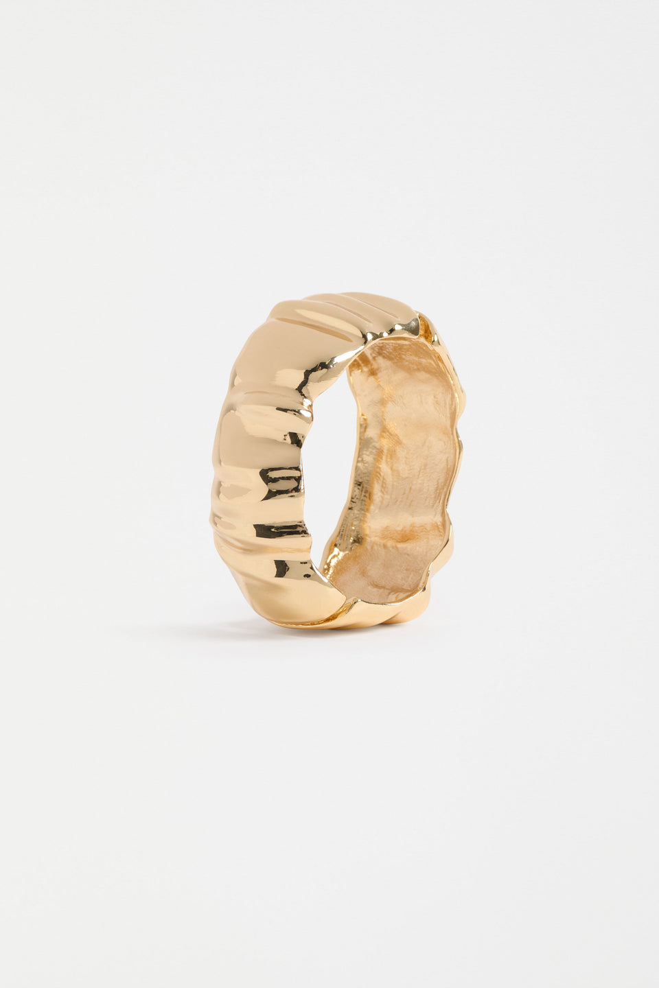 Sculptural metallic bangle with soft folds and a polished finish ELK | GOLD