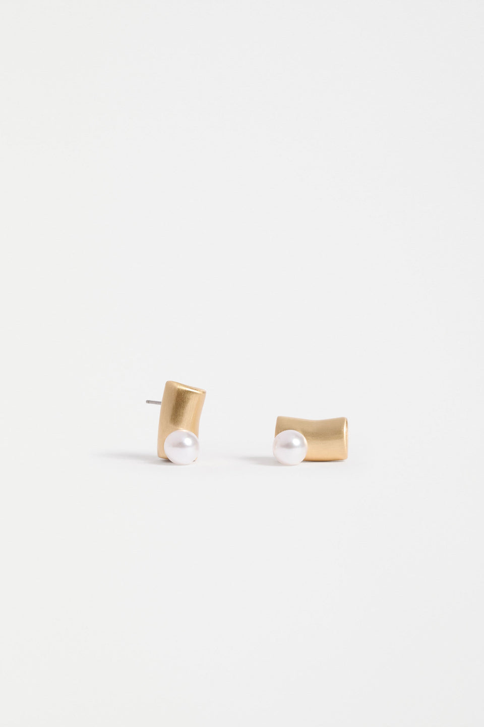 The Ahas Stud Earring features a sculptural curved form with a bold cylindrical base and delicate pearl bead accent | GOLD