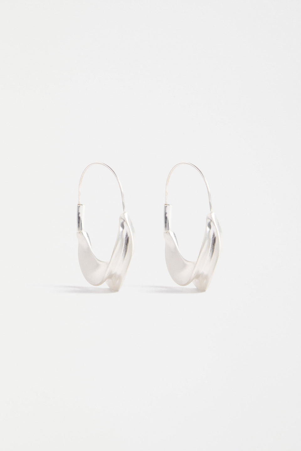 The Siita Hoop Earring features a sculptural petal-shaped base and fine closure for a modern take on the classic hoop | SILVER