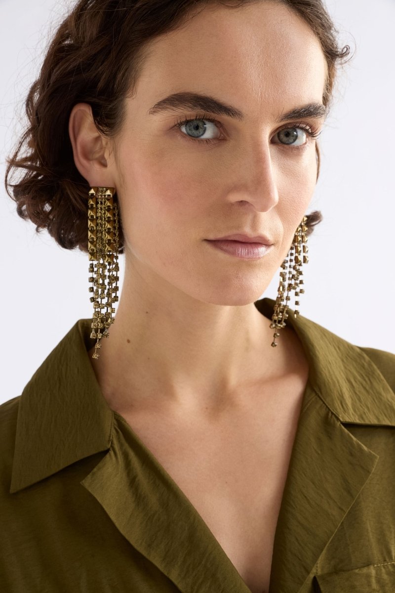 The Rutor Earring features dramatic long drops with tonal diamante chains and metallic studs in varied lengths for high-impact shine ELK | DUSTY ROSE