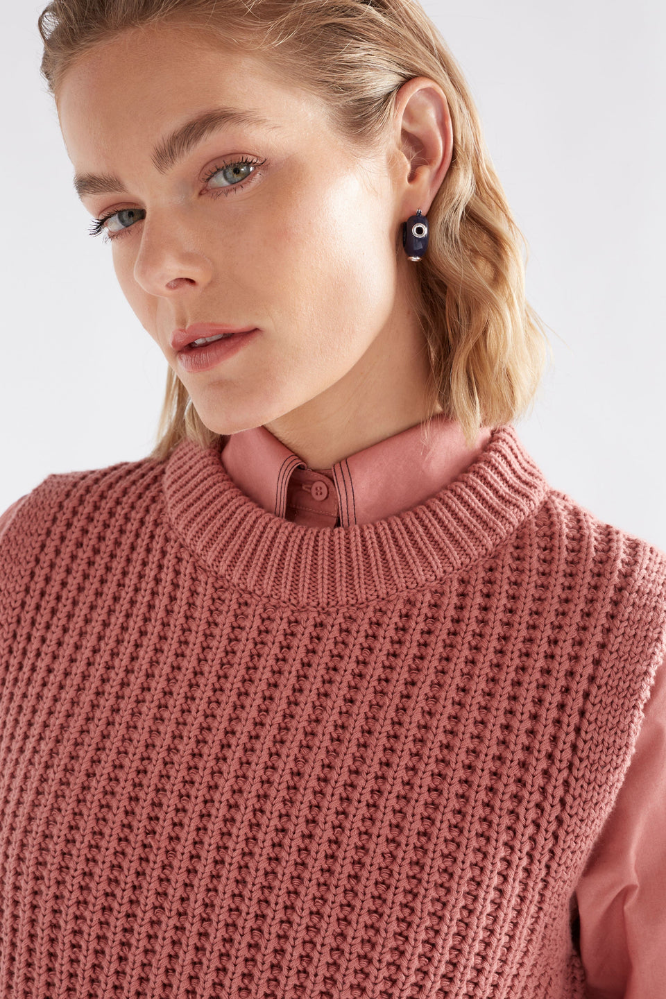 The Jans Hoop Earring features a chunky mini hoop silhouette with glossy enamel and metallic rivet detailing for a bold, playful finish, shown on model | BRIGHT NAVY