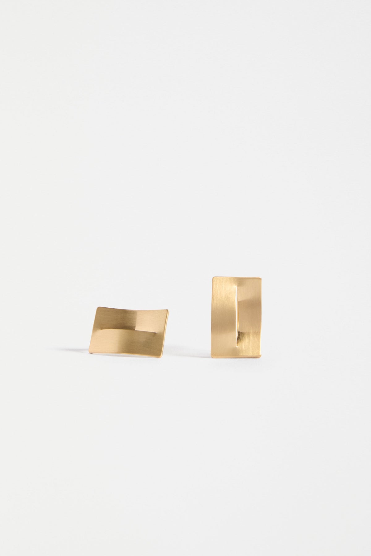 The Trel Stud Earring features a sleek rectangular shape with a folded cut-out detail, blending minimalism with sculptural edge | GOLD