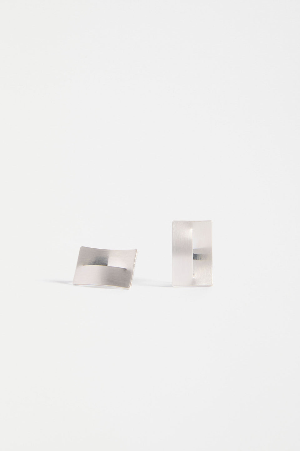 The Trel Stud Earring features a sleek rectangular shape with a folded cut-out detail, blending minimalism with sculptural edge | SILVER