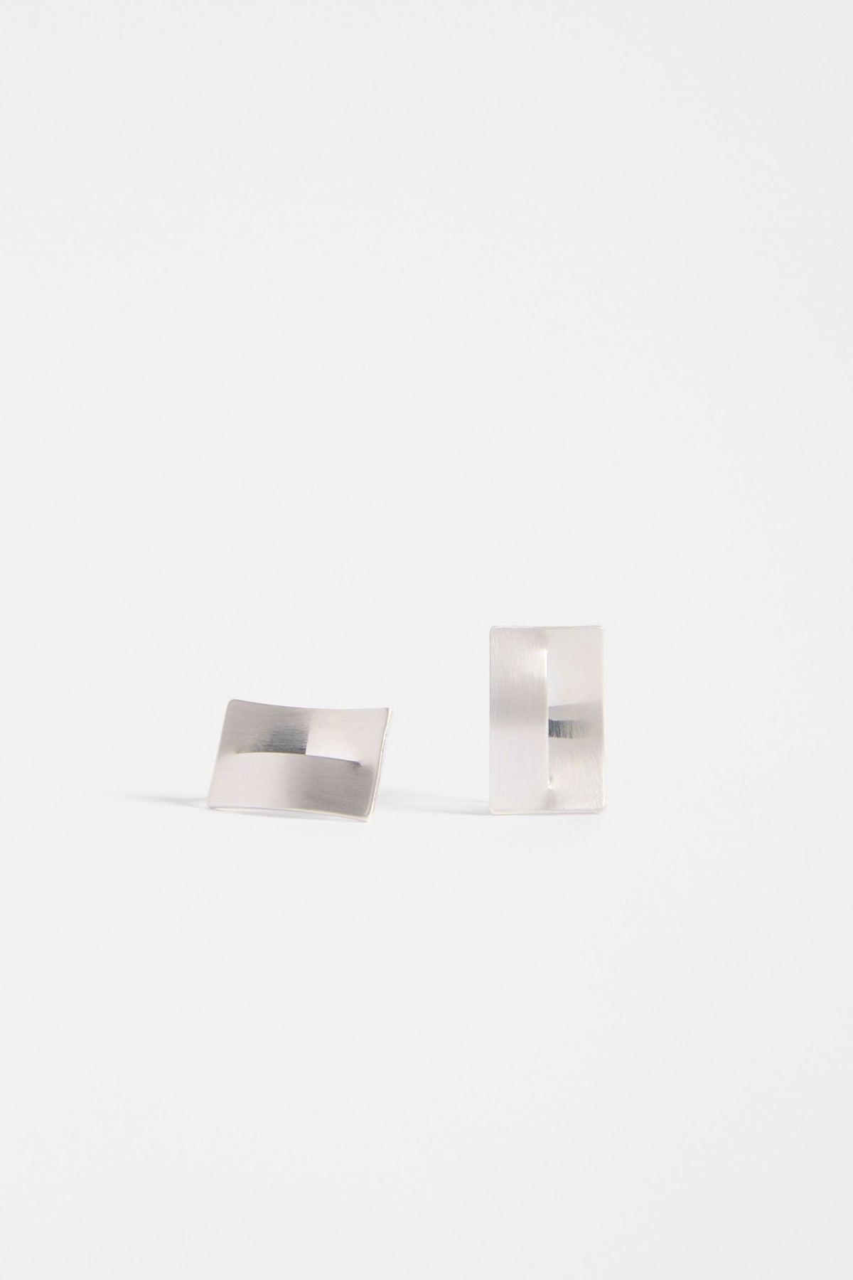 The Trel Stud Earring features a sleek rectangular shape with a folded cut-out detail, blending minimalism with sculptural edge | SILVER