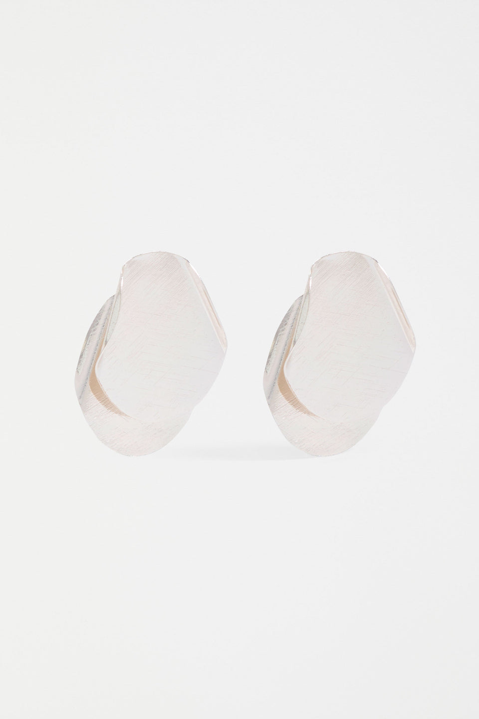 The Villt Earring features two overlapping petal-like forms crafted from fine, shiny metal for a lightweight sculptural statement ELK | SILVER