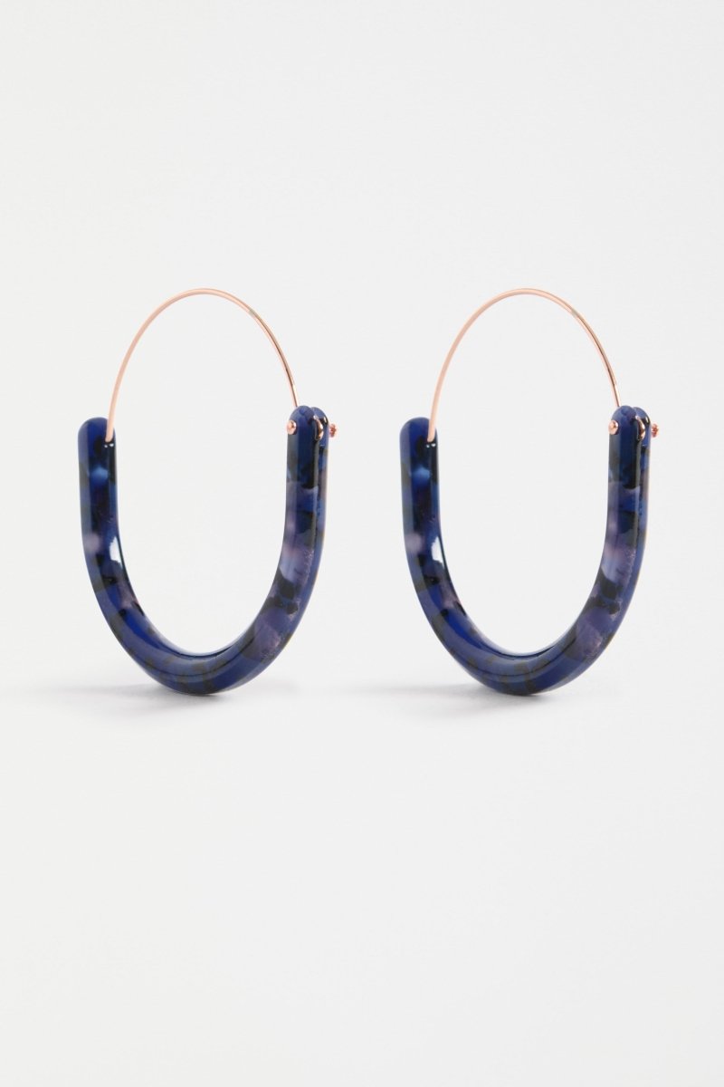 The Aki Hoop Earring features a large oval silhouette with layered acetate and a wire centre, offering a lightweight, modern statement | BLUE TORTOISESHELL