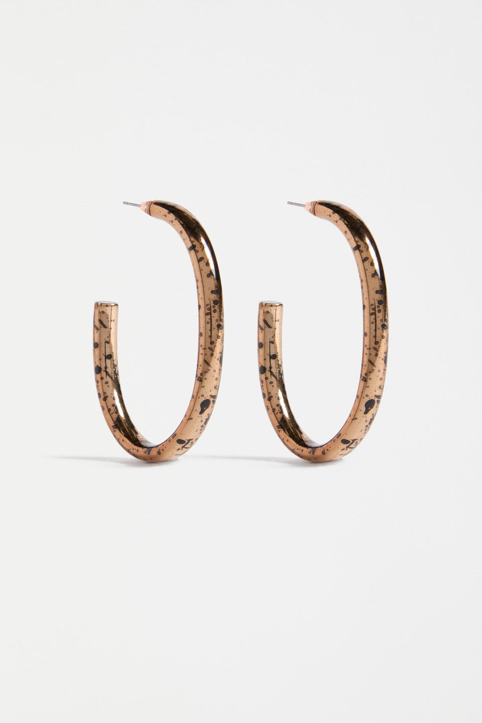 The Oban Large Hoop Earring features a bold open oval shape with a glistening metallic base and contrasting enamel splatter finish | BRONZE