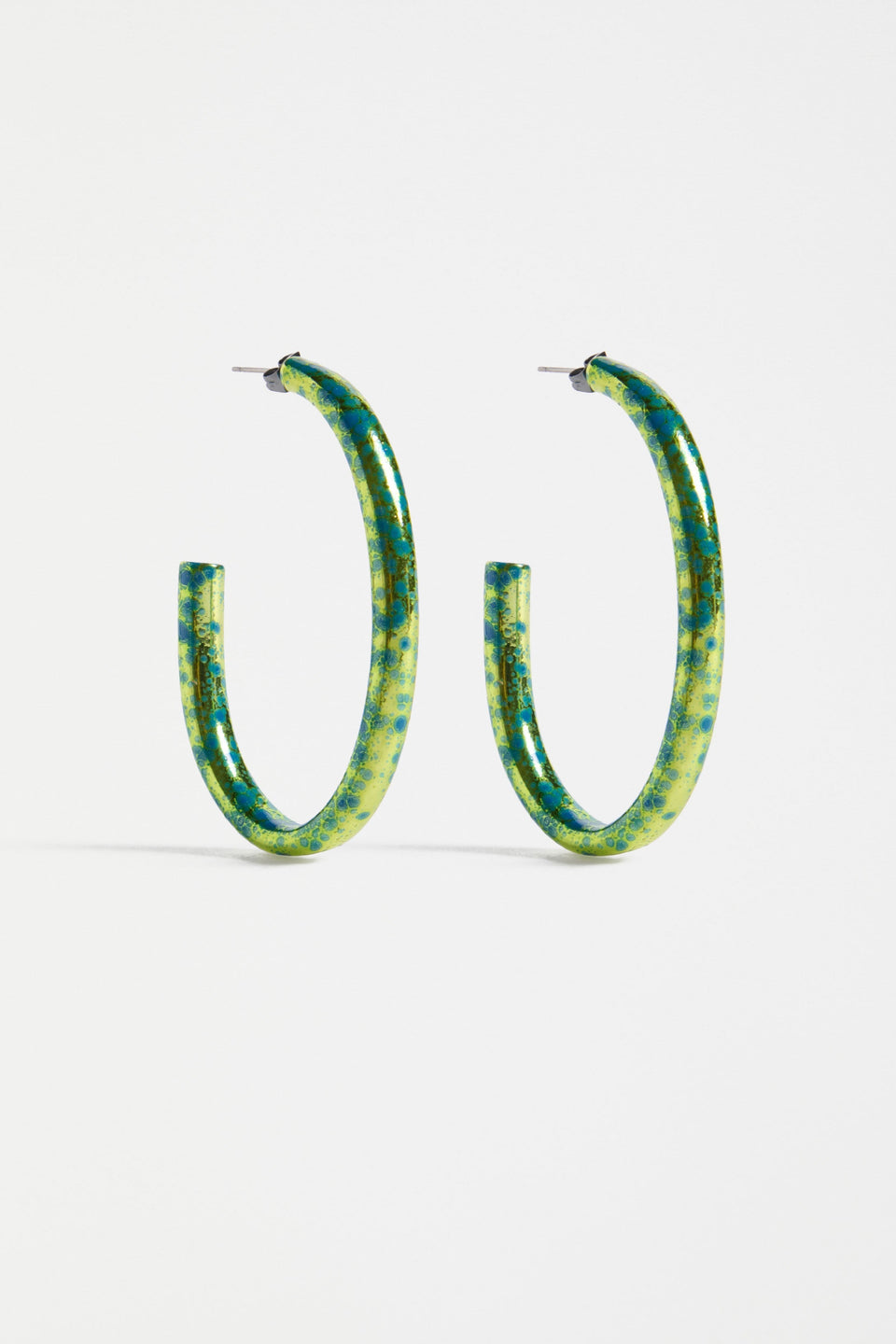 The Oban Large Hoop Earring features a bold open oval shape with a glistening metallic base and contrasting enamel splatter finish | ARTICHOKE