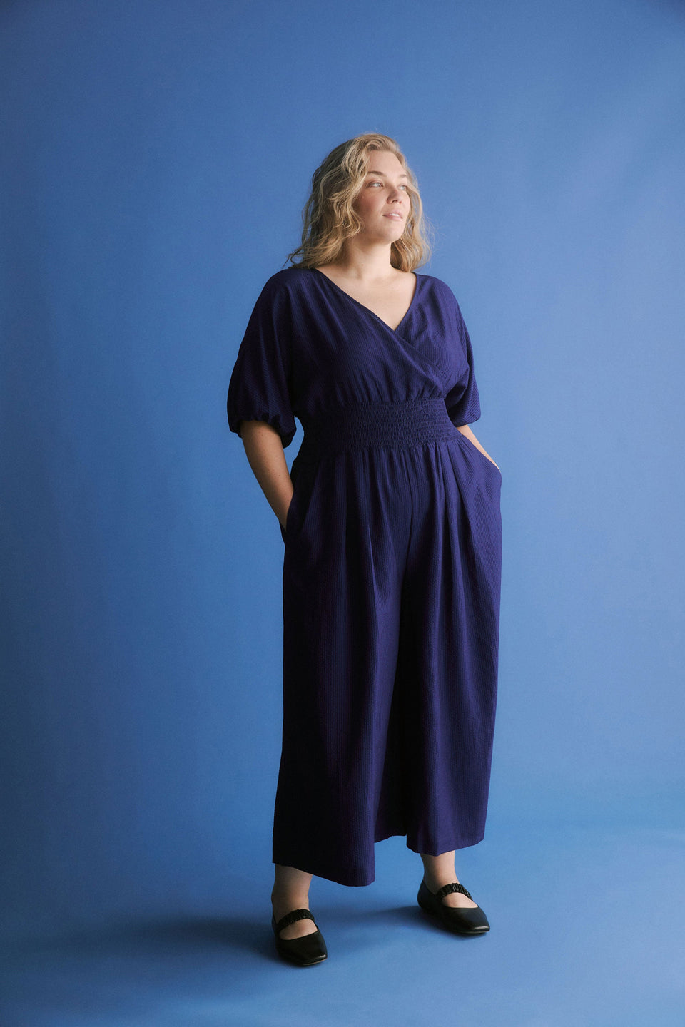 Stolt Seersucker Short Puff Sleeve Wide Leg Shirred Waist V-neck Jumpsuit ELK Curve campaign Model front | MID WASH