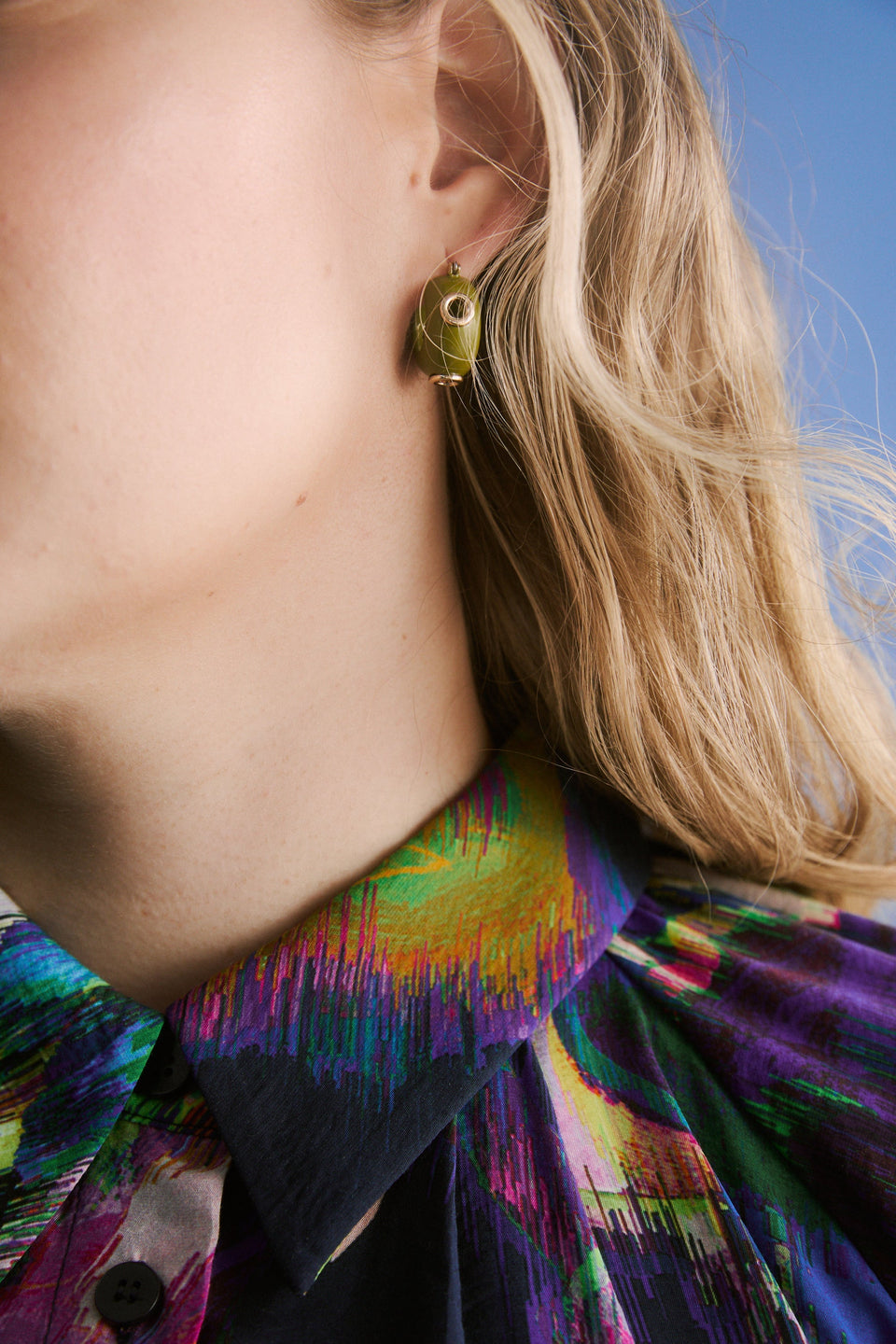 The Jans Hoop Earring features a chunky mini hoop silhouette with glossy enamel and metallic rivet detailing for a bold, playful finish campaign | CELERY