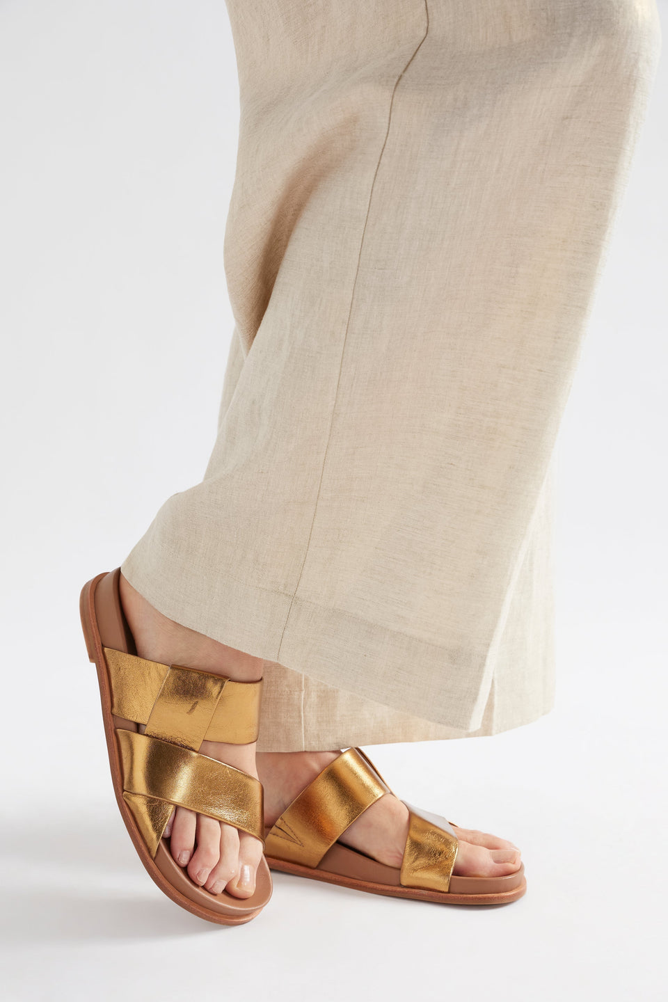 Uma Metallic Leather Cross Strap Slide Angled Front Model | GOLD