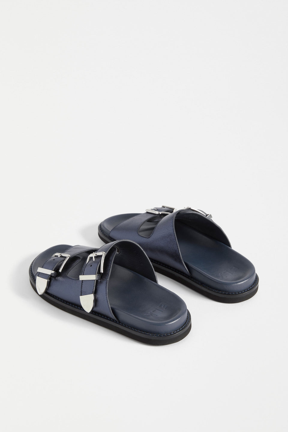 The Spenne Sandal features dual buckled foiled leather straps with tonal western hardware in a metallic slide design ELK | NAVY