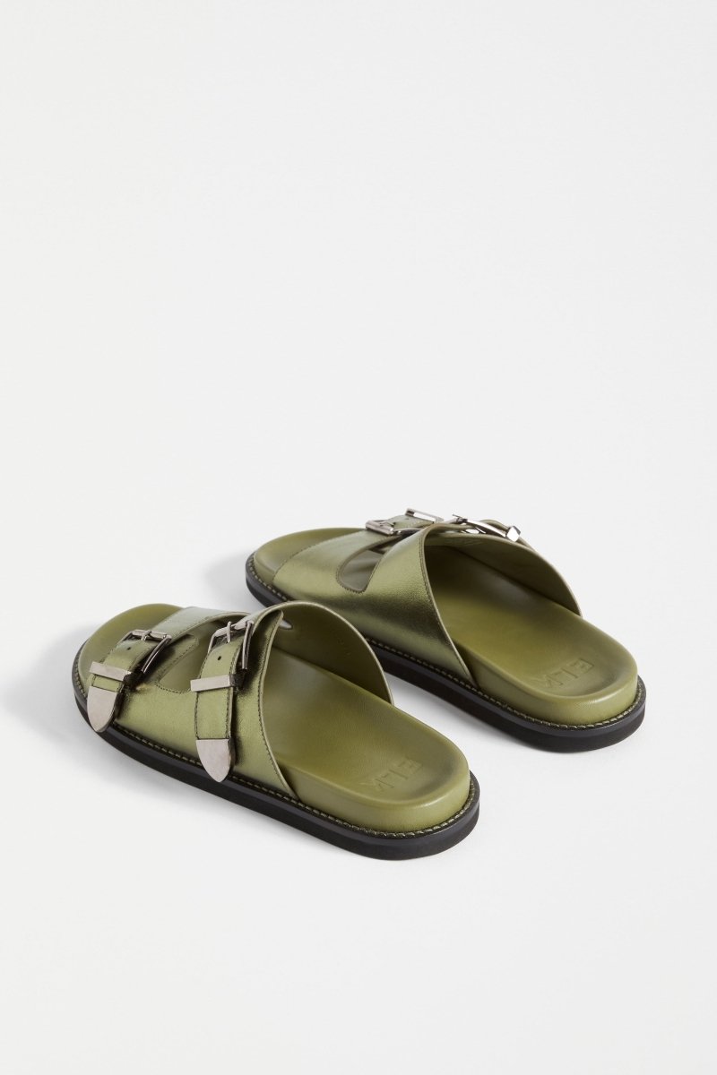The Spenne Sandal features dual buckled foiled leather straps with tonal western hardware in a metallic slide design ELK | OLIVE