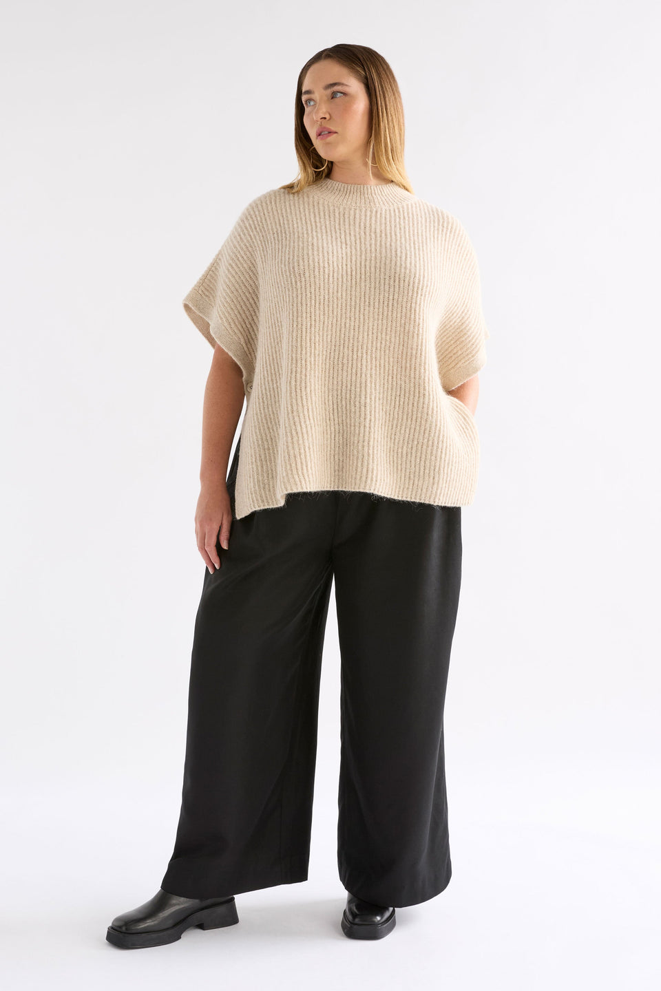 Kaanto Boxy Funnel Neck Rib Stitch Alpaca-Merino Wool Knit Poncho Model Chanel Front Full body | LATTE