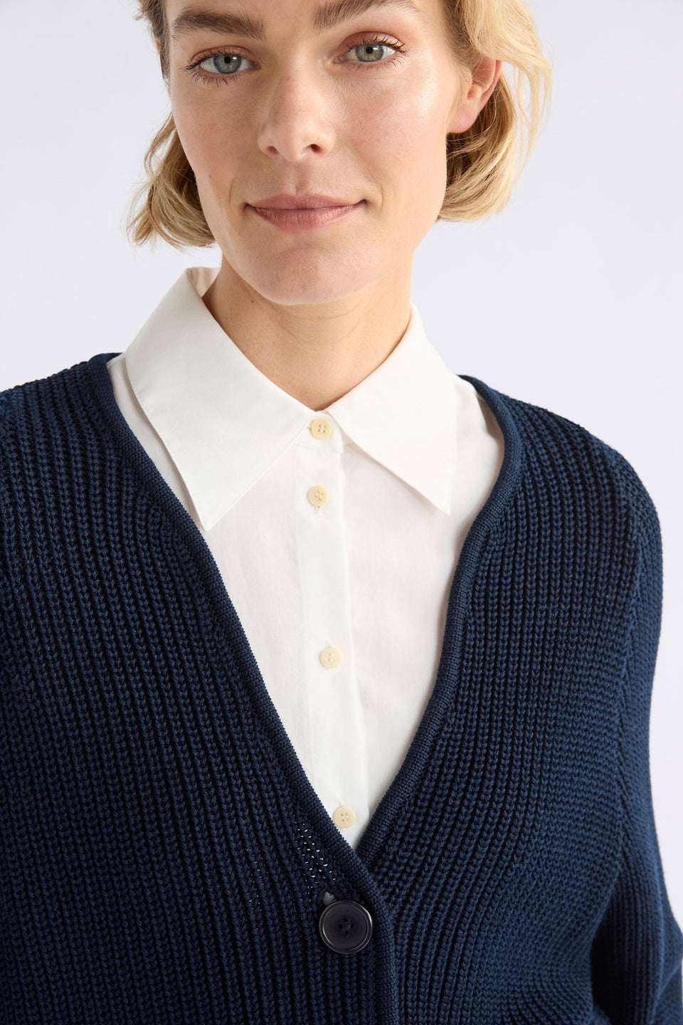 Saari Cardigan on Model Close Up with shirt and button | BRIGHT NAVY