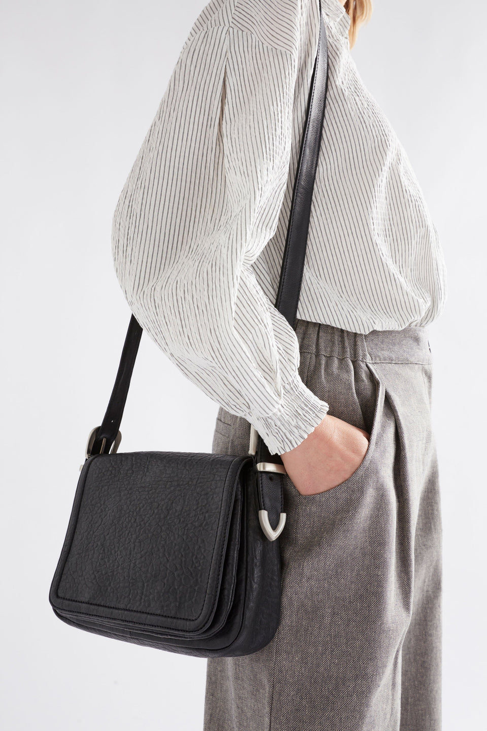 Spenne Crossbody Bag on model styled with pants and shirt | BLACK