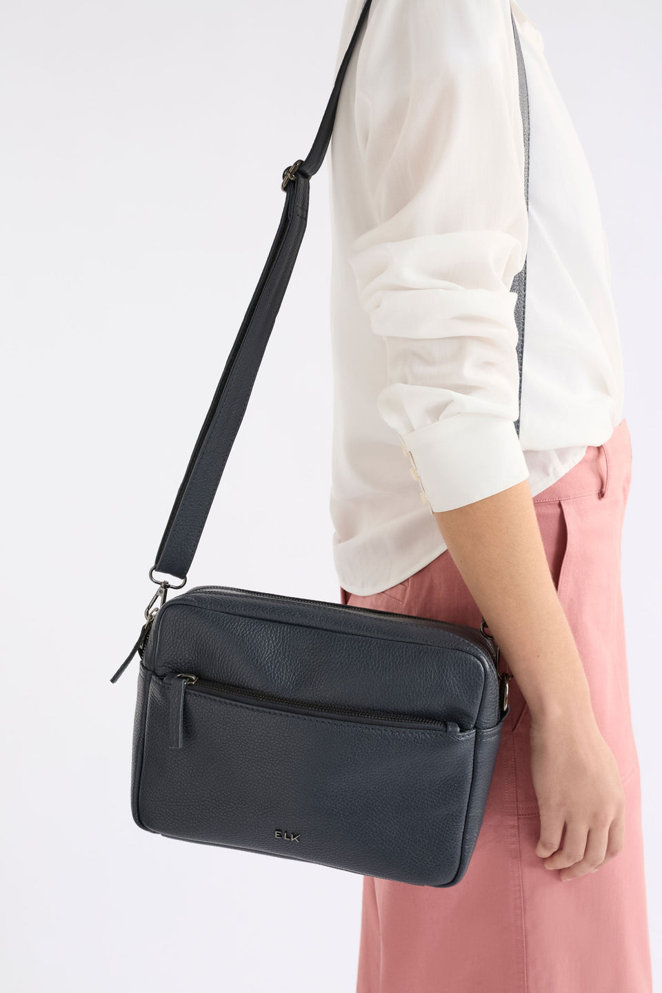 Olvi Crossbody Bag on model with zip pocket and strap | NAVY
