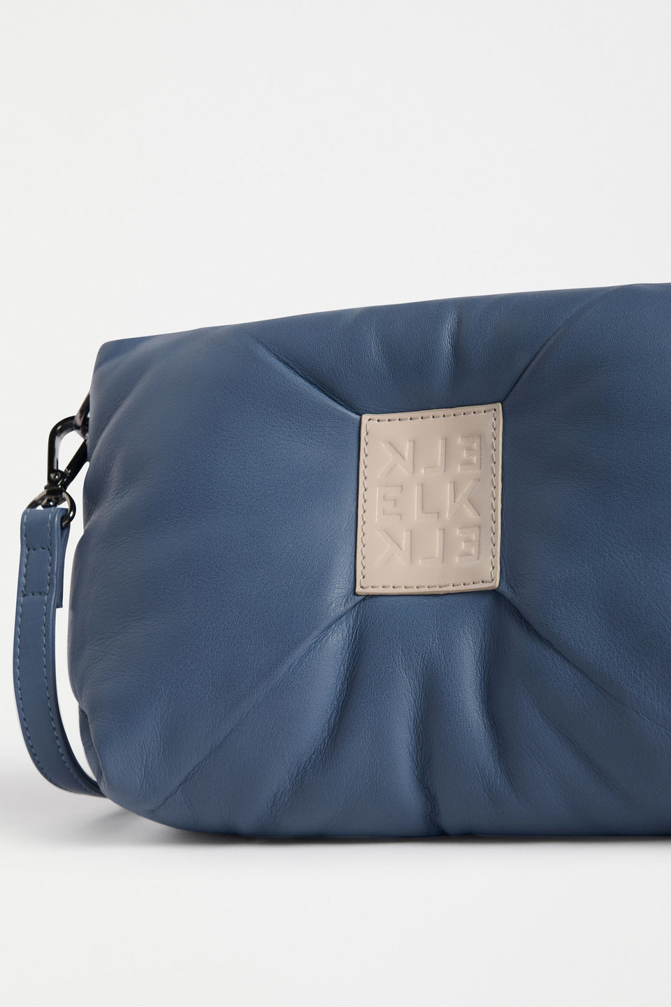 Moln Clutch Bag Flat Lay close up view of label | DENIM