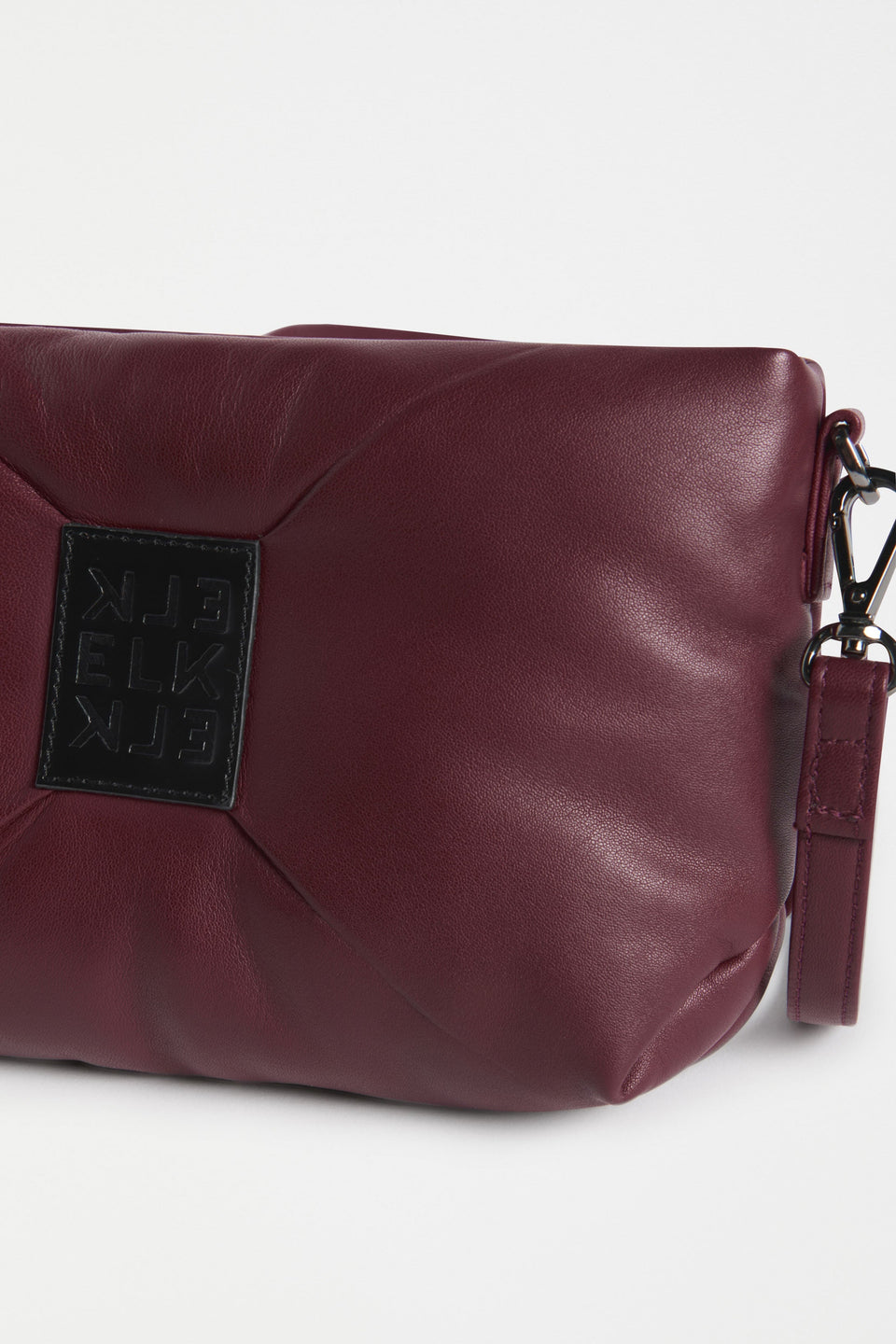 Moln Clutch Bag Flat Lay close up with and elk logo strap | BURGUNDY