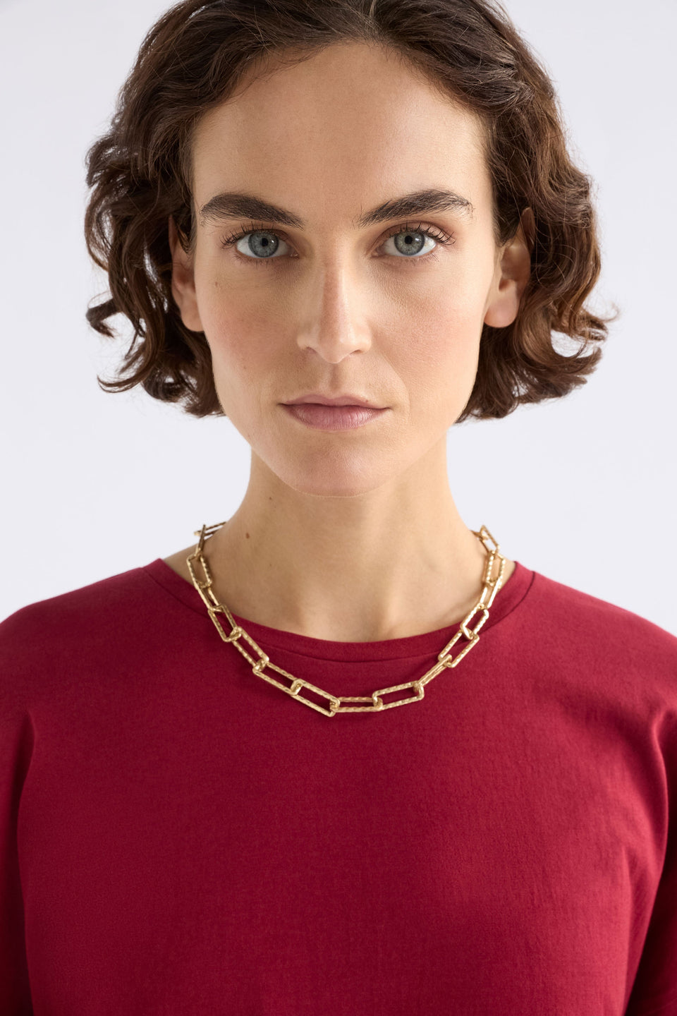 Ringva Necklace on model styled with red tshirt | GOLD