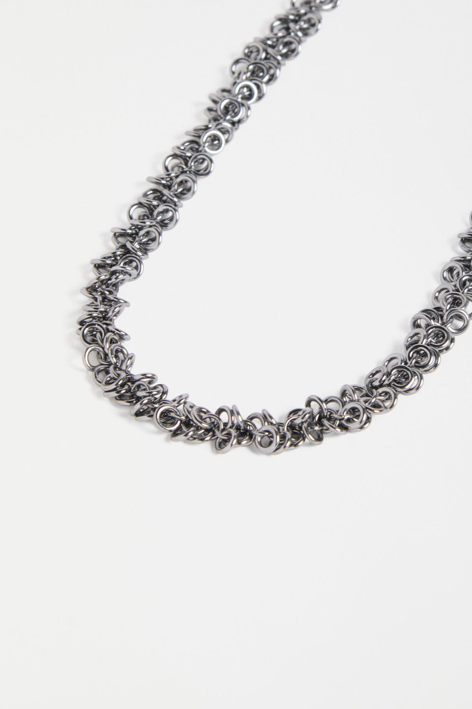 The Hava Necklace features layered metallic jump rings forming a thick, textured chain with sculptural impact ELK | GUNMETAL