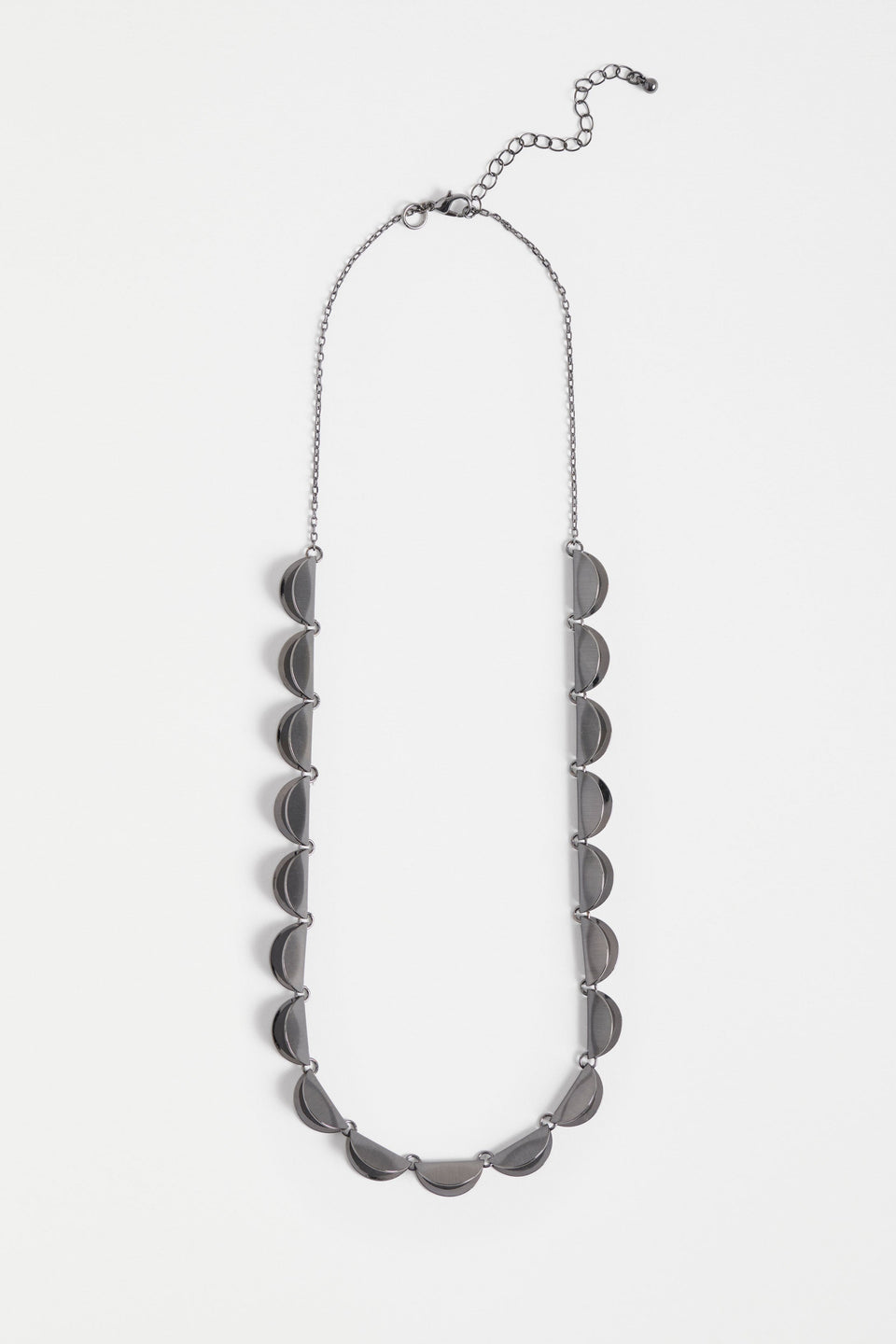 The Fossen Necklace features a row of brushed metal folded discs linked with jump rings on a fine chain ELK | GUNMETAL