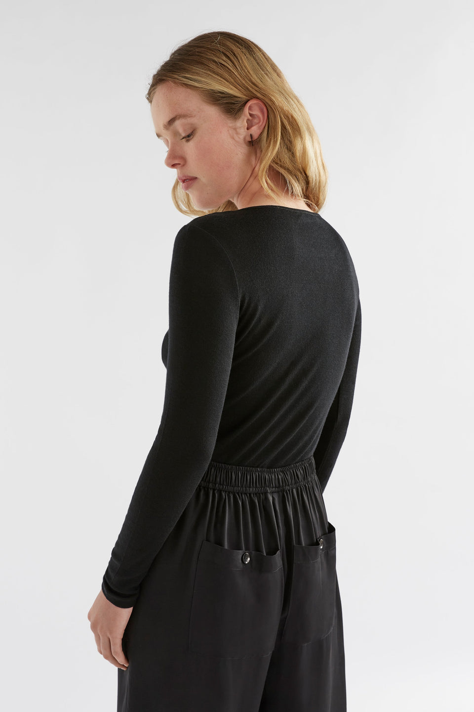 Merino Wool Long Sleeve Skin Top Model Bella Angled Back | BLACK