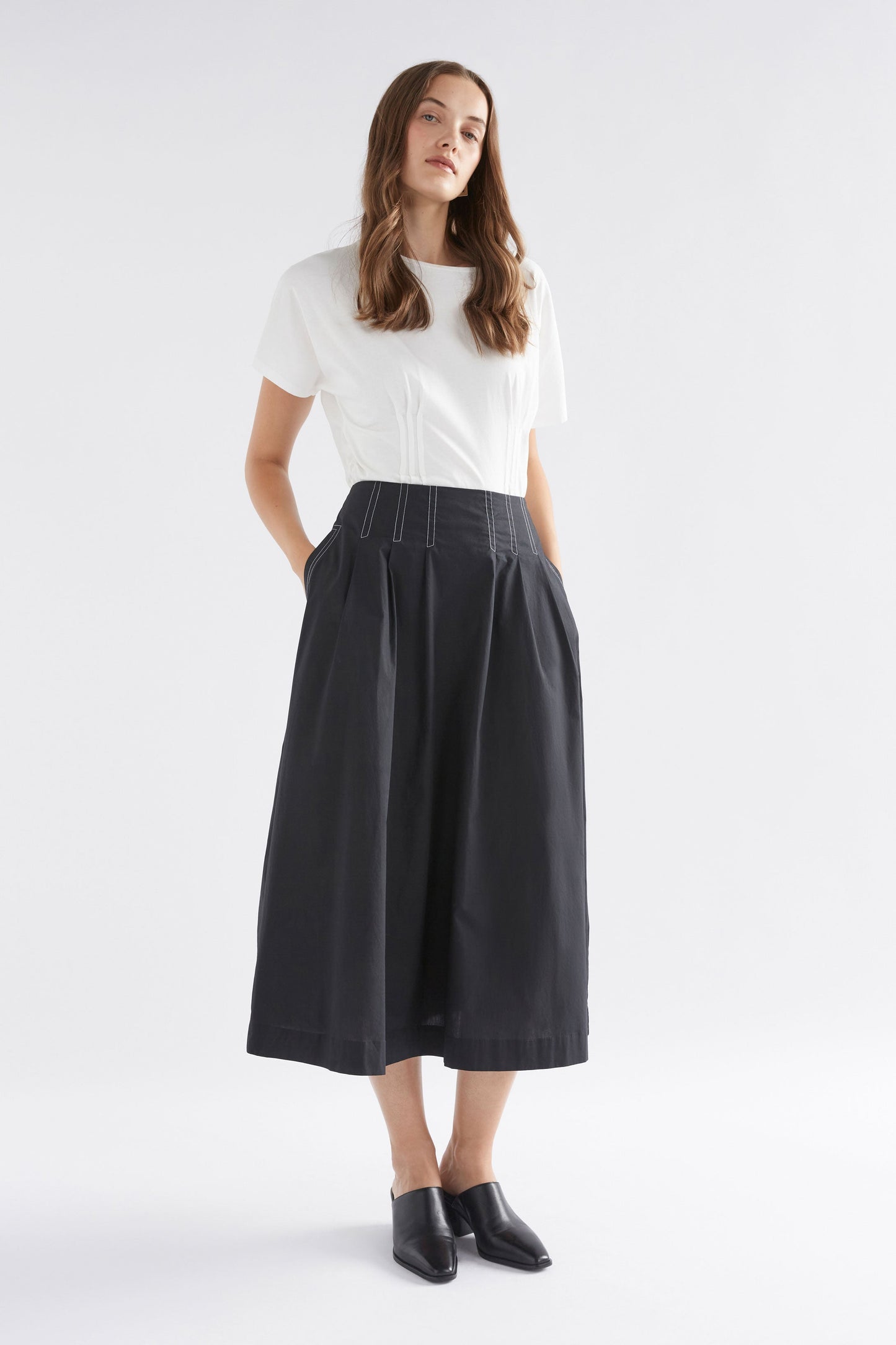 Takt Cotton Poplin Front Pleat Midi Skirt with Top Stitch Detailing Model Front Full Body | BLACK