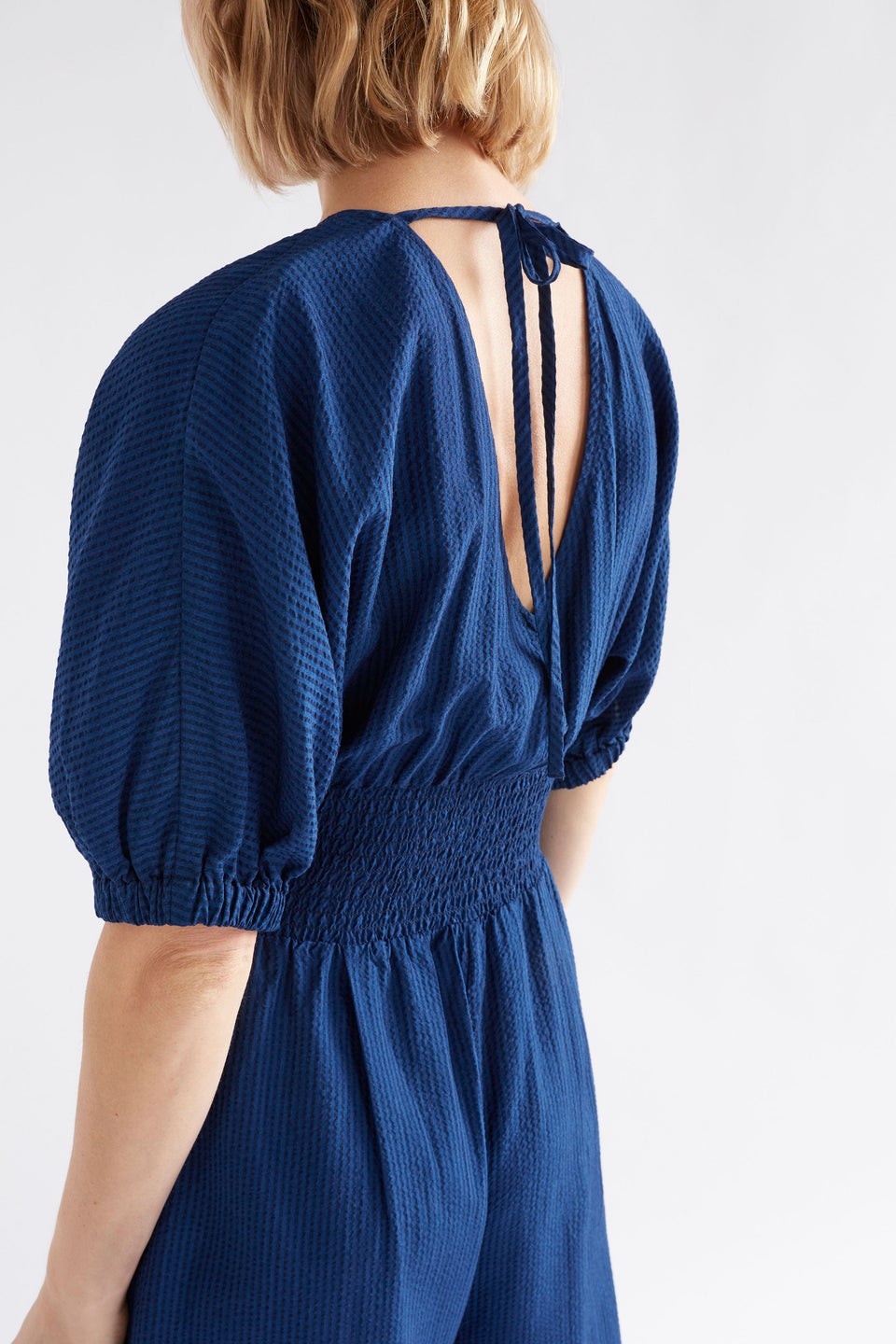 Stolt Seersucker Short Puff Sleeve Wide Leg Shirred Waist V-neck Jumpsuit ELK Model Back Detail | MID WASH