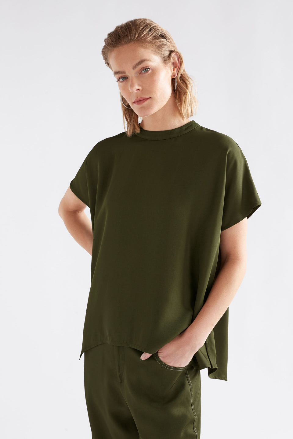 Hullu Relaxed Short Sleeve High Neck Top with Handkerchief Hem Model Front | BRIGHT OLIVE