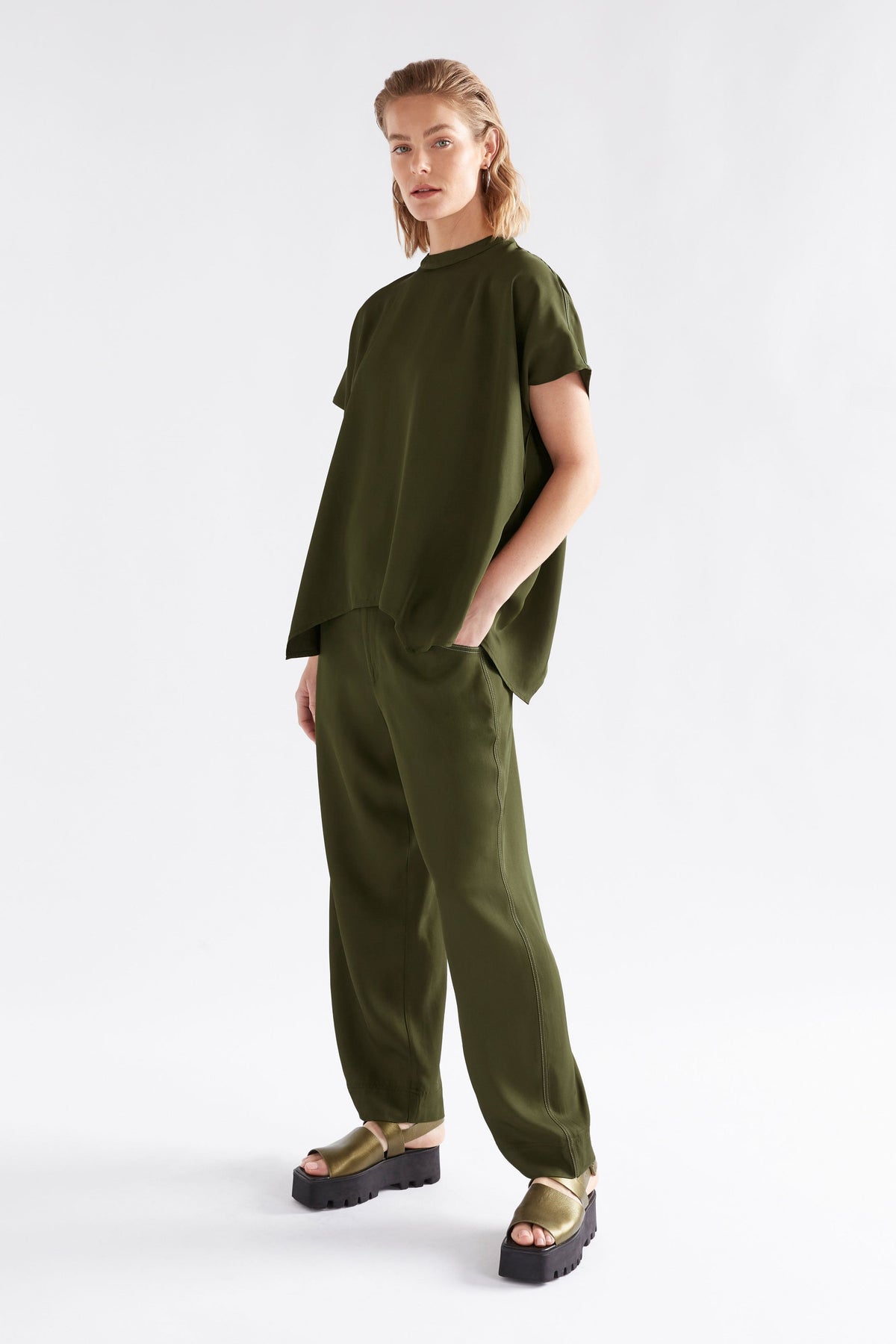 Hullu Relaxed Short Sleeve High Neck Top with Handkerchief Hem Model Front with hullu top | BRIGHT OLIVE