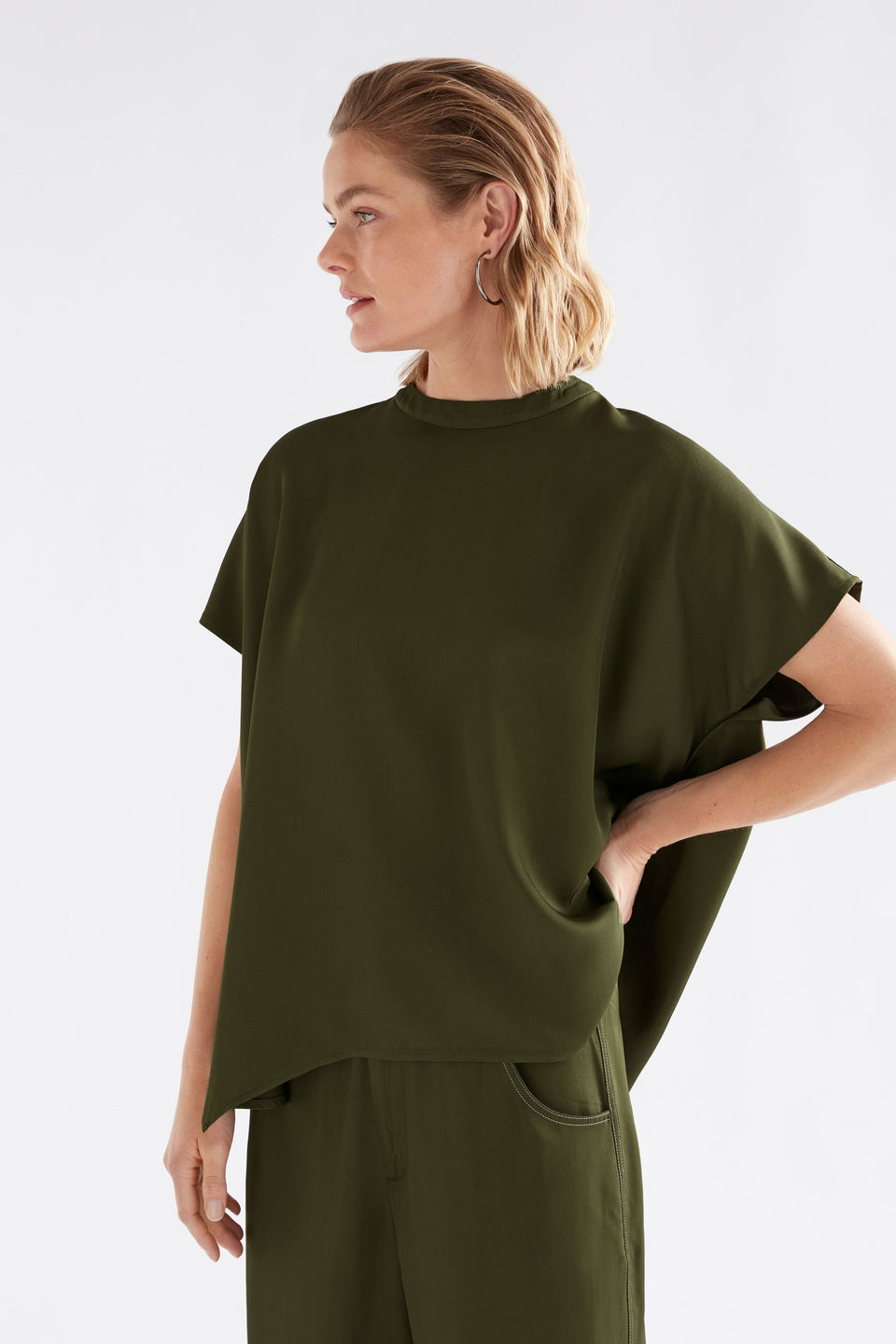 Hullu Relaxed Short Sleeve High Neck Top with Handkerchief Hem Model Front crop | BRIGHT OLIVE