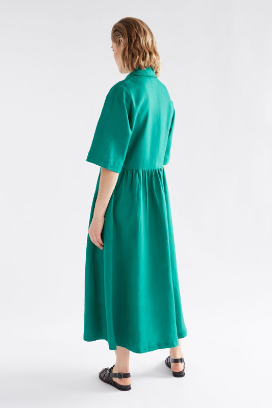 Llinen Long Waisted Short Sleeve Linen Shirt Dress Green Model Angled Back | DEEP TEAL