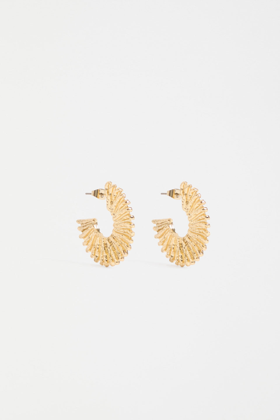 The Krusen Hoop Earring features a mid-sized open hoop crafted from shiny metal with a distinctive ridged texture ELK | GOLD
