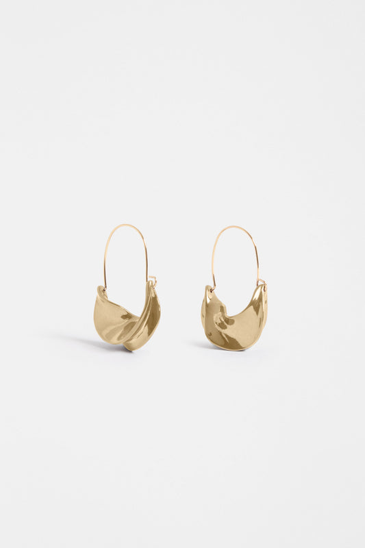 The Siita Hoop Earring features a sculptural petal-shaped base and fine closure for a modern take on the classic hoop | GOLD