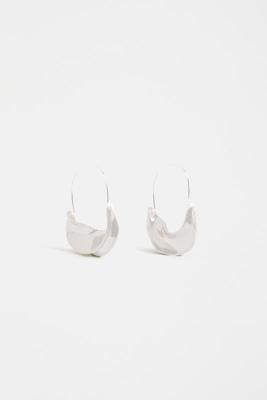 The Siita Hoop Earring features a sculptural petal-shaped base and fine closure for a modern take on the classic hoop | SILVER