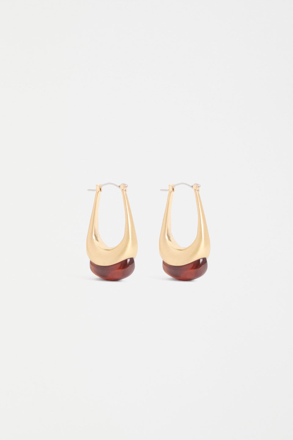 The Korvvo Long Hoop Earring features a sculptural elongated hoop with dramatic length, finished with a chunky flecked glass bead ELK | RED