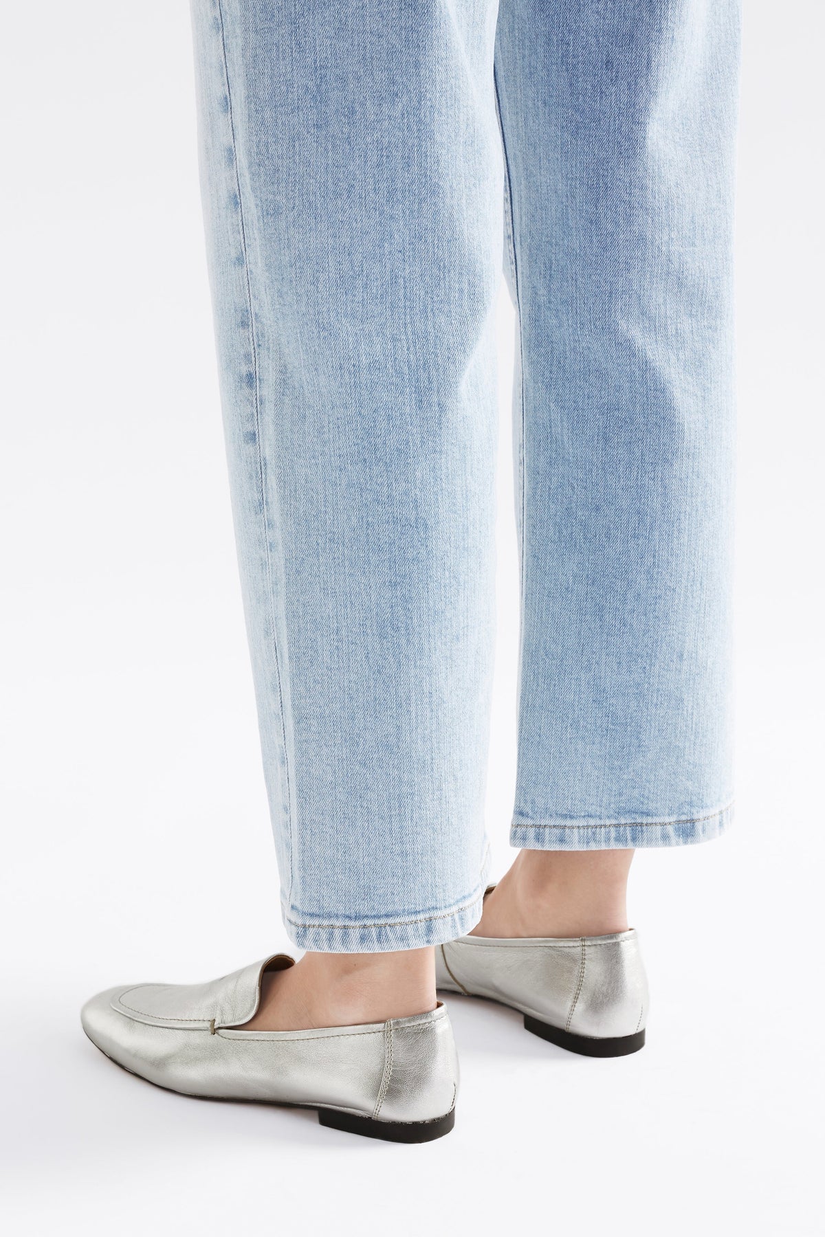 Clift Metallic Silver Leather Flat Loafer Angled Back Model | SILVER