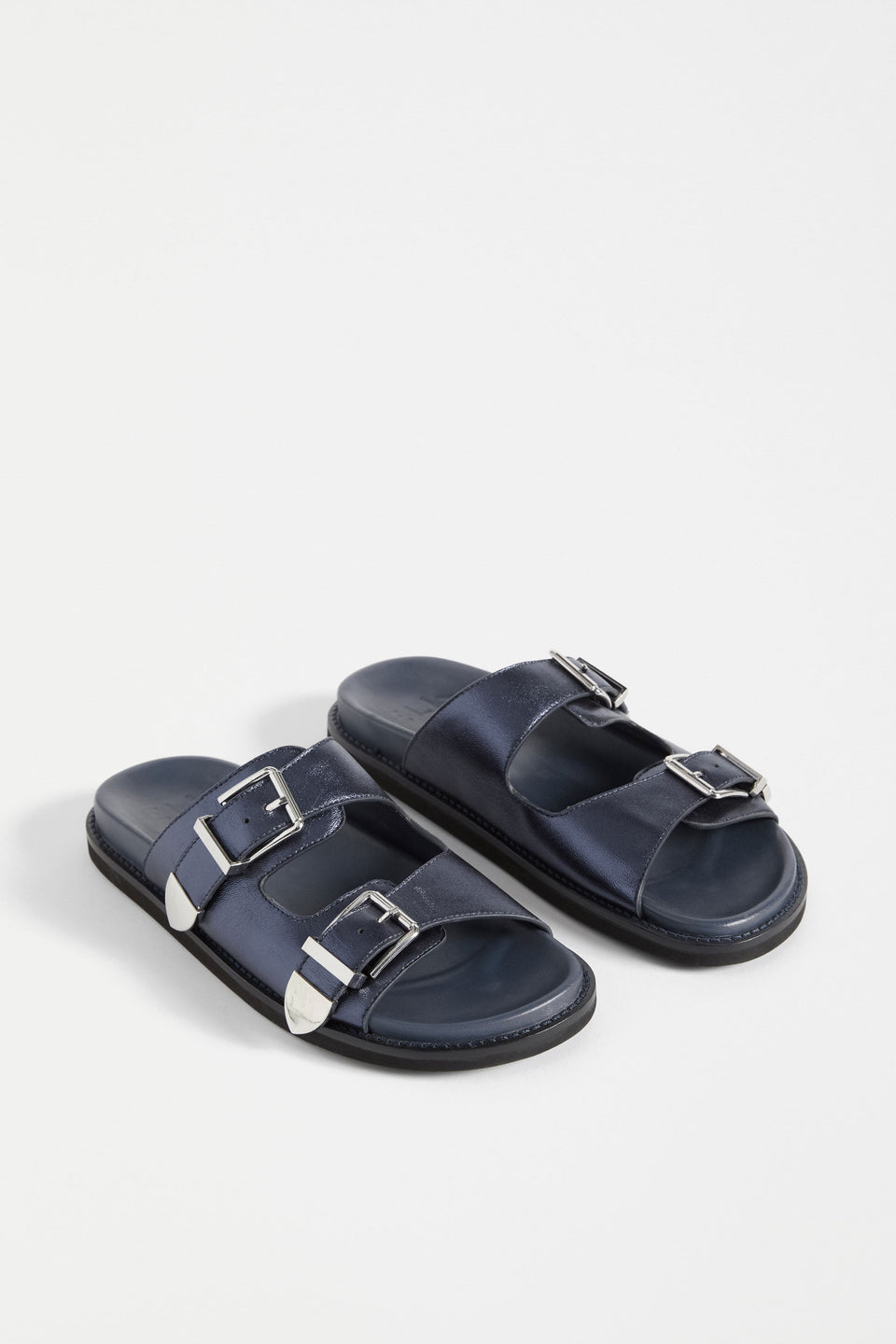 The Spenne Sandal features dual buckled foiled leather straps with tonal western hardware in a metallic slide design ELK | NAVY