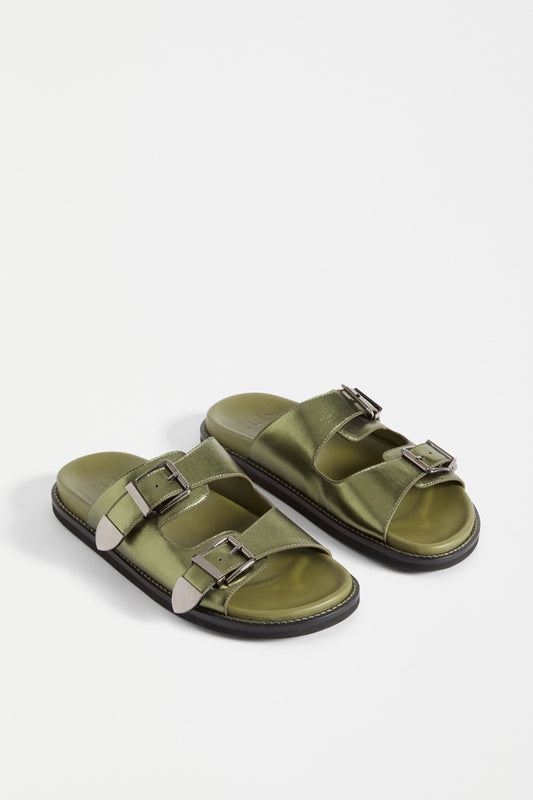 The Spenne Sandal features dual buckled foiled leather straps with tonal western hardware in a metallic slide design ELK | OLIVE
