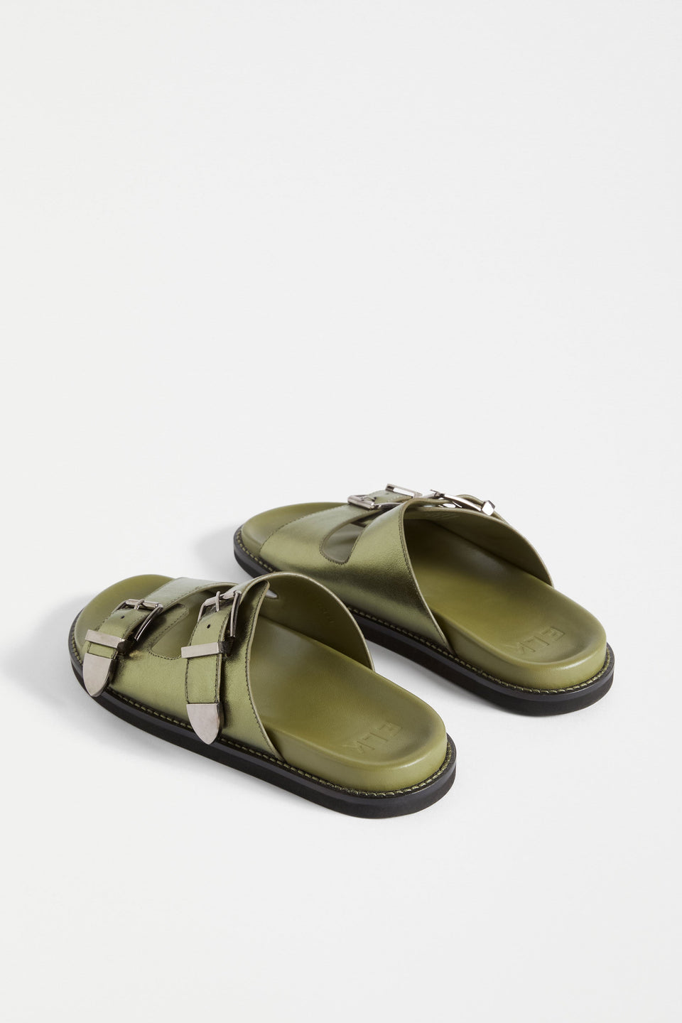 The Spenne Sandal features dual buckled foiled leather straps with tonal western hardware in a metallic slide design ELK | OLIVE