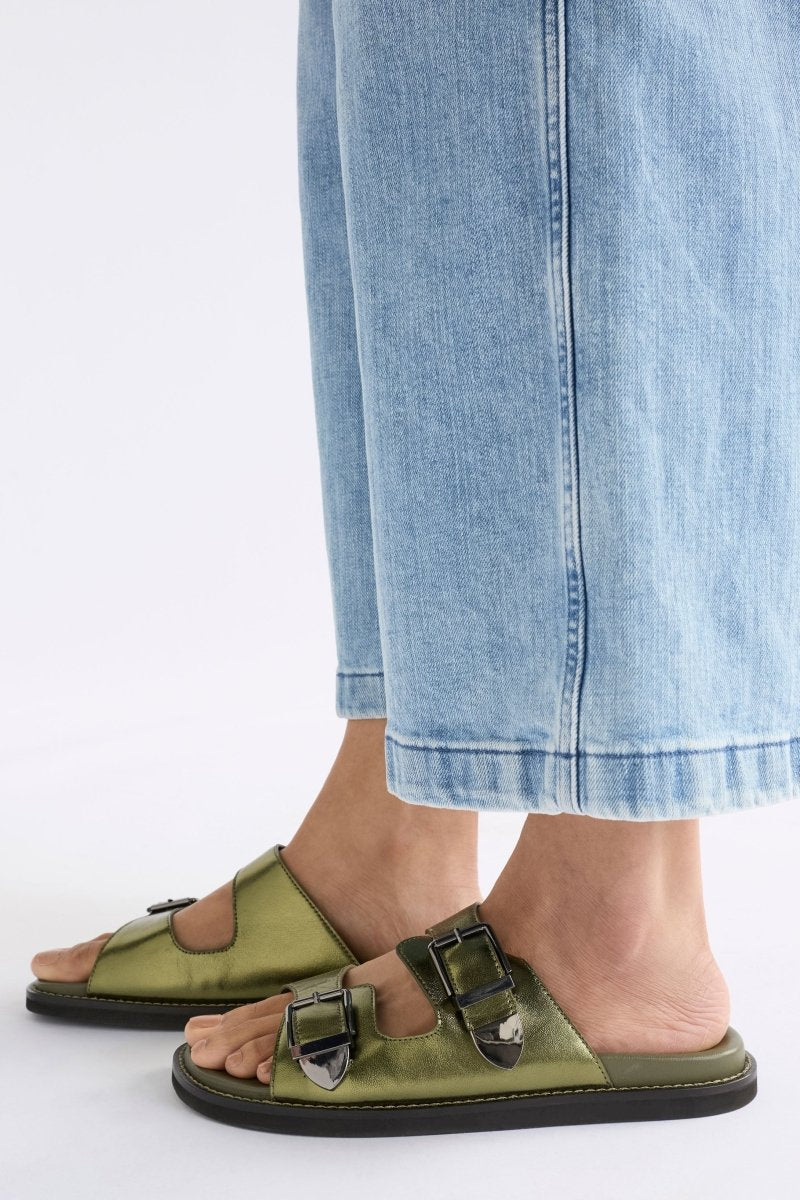 The Spenne Sandal features dual buckled foiled leather straps with tonal western hardware in a metallic slide design ELK | OLIVE