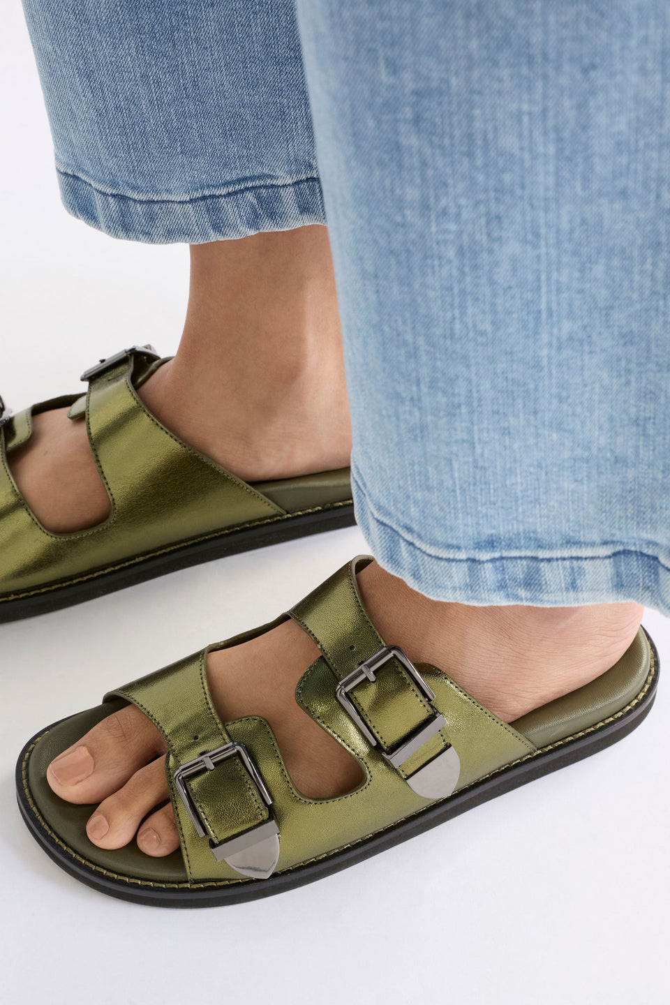 The Spenne Sandal features dual buckled foiled leather straps with tonal western hardware in a metallic slide design ELK | OLIVE