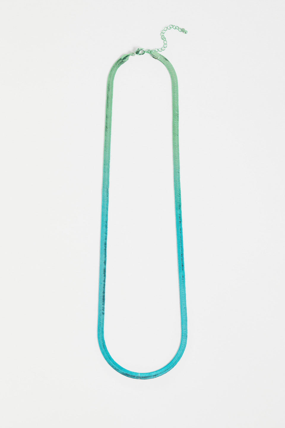The Vera Long Necklace features a wide, flat snake chain in a shiny ombré finish, adding glistening colour and movement to any look ELK | GREEN-BLUE OMBRE