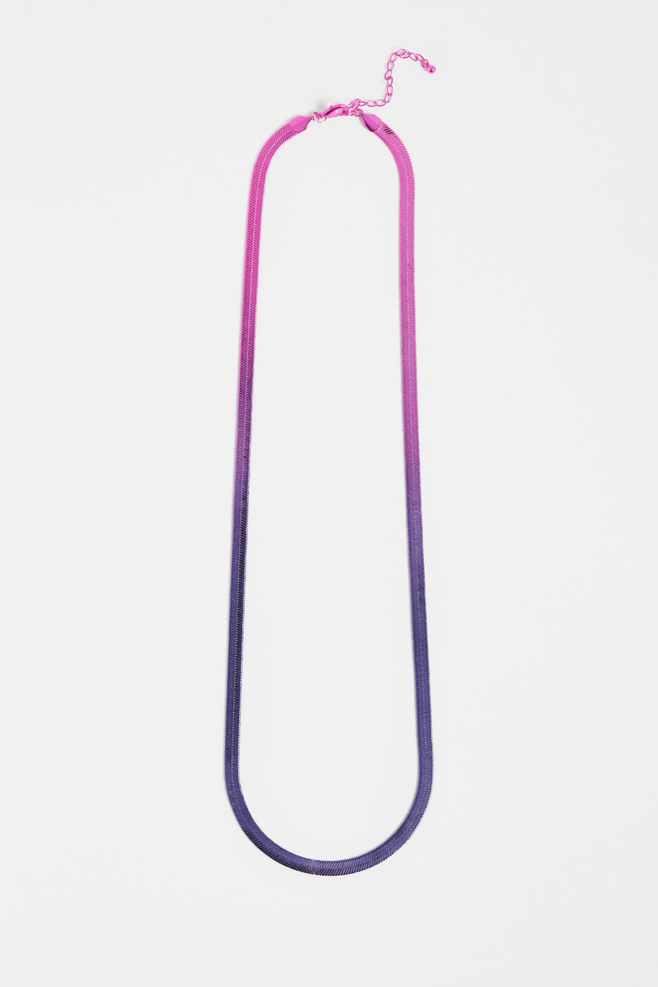 The Vera Long Necklace features a wide, flat snake chain in a shiny ombré finish, adding glistening colour and movement to any look ELK | NAVY-PINK OMBRE